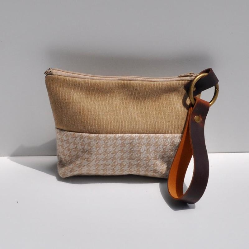 wristlet, herringbone fabric, zippered enclosure, thick leather strap, small bag, makeup bag